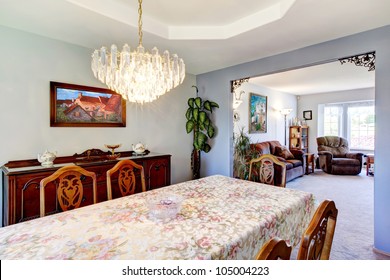 Dining Room With A Large Table And Art In An Outdated American House.