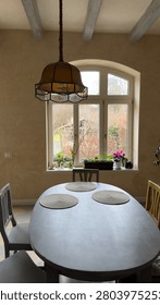 Dining room with a large table and chairs in front of the window