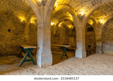 Dining room in medieval arched vault with furniture and columns - Powered by Shutterstock