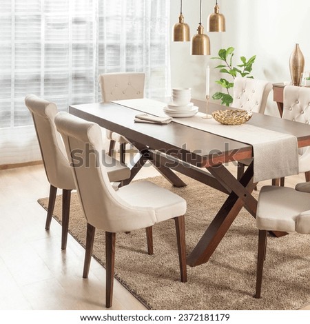 Dining Room with Rectangle Wooden Dining Table Set and Fabric Beige Button Dining Chairs with Wooden Legs, Adorned by Linen Table Runner, White Ceramic Dinnerware Set, and Ornaments on the Table.