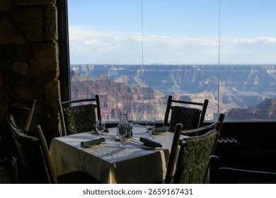 Dining room table with a view into the Grand Canyon from the historic lodge on the north rim of Grand Canyon National Park, summer vacation, Arizona, USA

