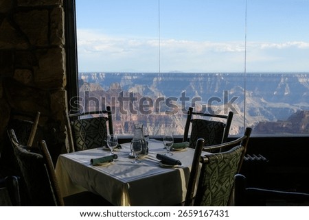 Dining room table with a view into the Grand Canyon from the historic lodge on the north rim of Grand Canyon National Park, summer vacation, Arizona, USA
