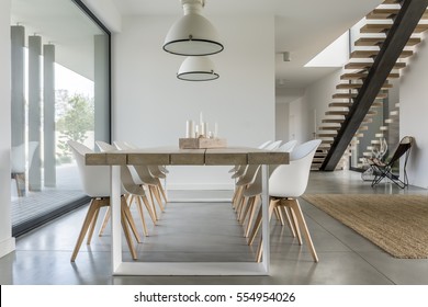 Dining Room With Window, Ceiling Lamp And Stairs