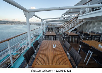 Dining Scene At A Cruise Ship With Tables And Chairs