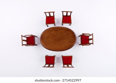 Dining setup with wooden table and red chairs arranged in a circle in a neutral space for gathering and conversation