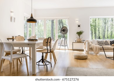 Dining space with wooden table in cozy modern lounge - Powered by Shutterstock