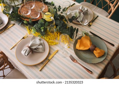 Dining table with beautiful setting and floral decor - Shutterstock ID 2135320323