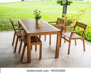 Dining Table With Chair Made Of Wood On The Outside Surround With Garden Green Field