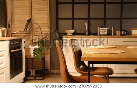 Dining table with chairs in kitchen at night