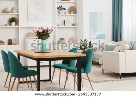 Dining table and chairs in room. Interior design with color accent