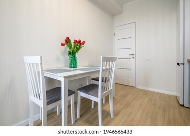 Dining Table At Cozy Well Designed White Modern Kitchen Interior