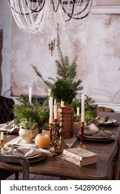 Dining Table Decorated For Christmas And Evergreen Centerpiece.