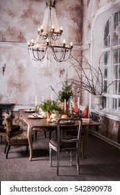 Dining Table Decorated For Christmas And Evergreen Centerpiece.