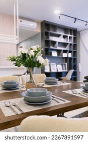 dining table with full sets cutleries and flowers
