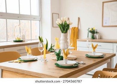 Dining table set for Easter with tulips in light kitchen