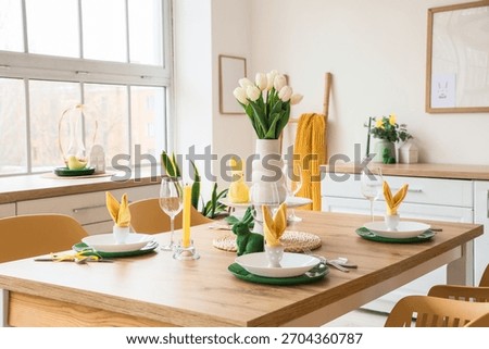 Dining table set for Easter with tulips in light kitchen