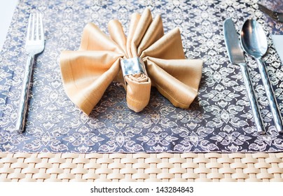 Dining table setting with fork, knife, spoon  and napkin