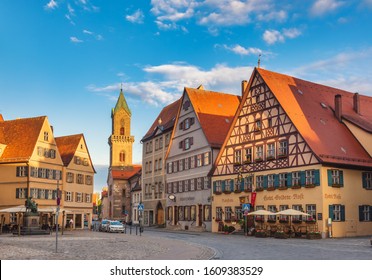 Dinkelsbuhl, Germany - May 11, 2019: Hotels and shops along the Marktplatz (Market Square) with St. Paul's Church in background