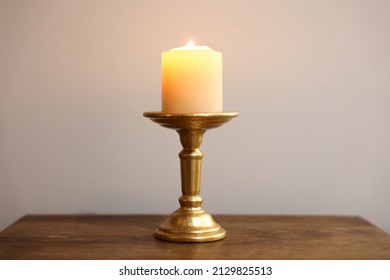 Dinner By Candlelight. Warm Candle On Vintage Golden Holder With White Background