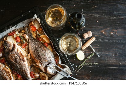 Dinner Concept For Two. Two Glasses Of White Wine, Baked Fish.