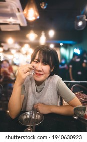 Dinner Couple Date At Indoor Restaurant Concept. Portrait Happy Smile Young Adult Asian Woman Cheer With Soju At Korean Chicken Meal. Foodie People Lifestyle.