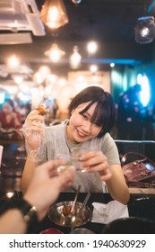 Dinner Couple Date At Indoor Restaurant Concept. Portrait Happy Smile Young Adult Asian Woman Cheer With Soju At Korean Chicken Meal. Foodie People Lifestyle.