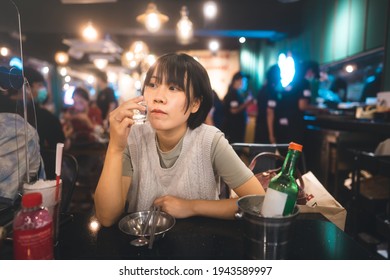 Dinner Couple Date At Indoor Restaurant Concept. Portrait Happy Smile Young Adult Asian Woman Cheer With Soju At Korean Chicken Meal. Foodie People Lifestyle.