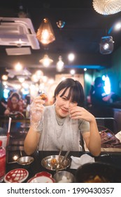 Dinner Couple Date At Indoor Restaurant Concept. Portrait Happy Smile Young Adult Asian Woman Cheer With Soju At Korean Chicken Meal. Foodie People Lifestyle.