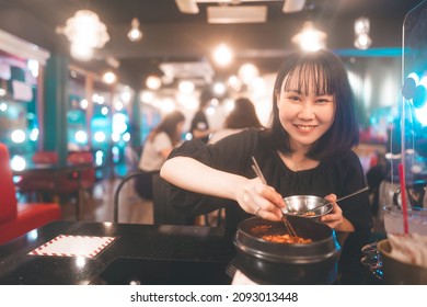 Dinner Couple Date At Indoor Restaurant Concept. Portrait Happy Smile Young Adult Asian Woman Eating Ramyeon Noodle At Korean Chicken Meal. Foodie People Lifestyle.