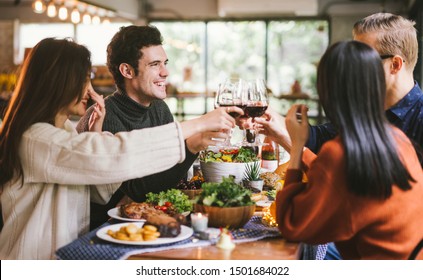 Dinner with friends. Group of young people enjoying dinner together. Dining Wine Cheers Party thanksgiving Concept - Powered by Shutterstock