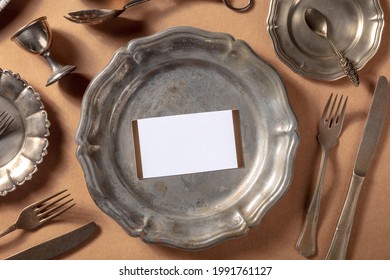 Dinner Invitation Mockup With An RSVP Card, Shot From The Top On A Vintage Silver Salver With Other Elegant Tableware And Cutlery, Overhead Flat Lay Mock Up For A Formal Occasion