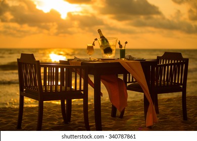 Dinner on the beach on sunset time - Shutterstock ID 340787861