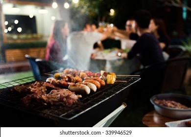Dinner party, barbecue and roast pork at night - Shutterstock ID 339946529