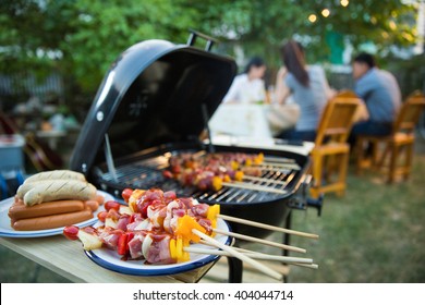 Dinner party, barbecue and roast pork at night - Shutterstock ID 404044714