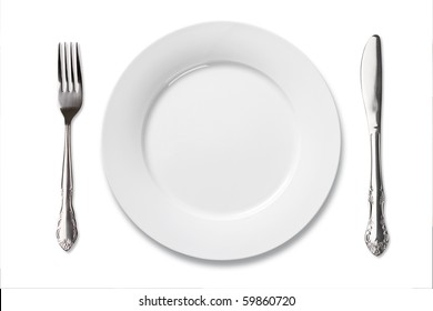 Dinner Place Setting. A White China Plate With Silver Fork And Knife Isolated On White Background.