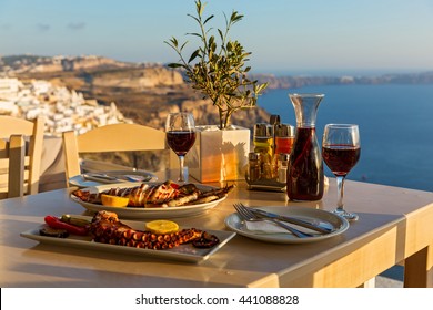 Dinner With Seafood And Red Wine On The Background Of Sea Sunset