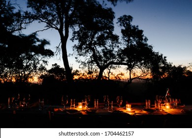 Dinner At Sunset On A Summer Night Outside Al Fresco By Candle Light Under The Oak Trees