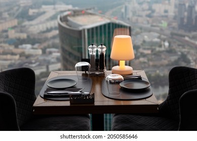 Dinner at sunset with panoramic views of the Moscow business center. Dinner on the background of the city. Restaurant overlooking downtown. Romantic setting, Moscow, Russia