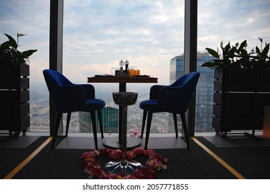 Dinner at sunset with views of the Moscow business center. Dinner on the background of the city. Restaurant overlooking downtown. Romantic setting, Moscow, Russia