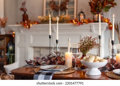Dinner table decorated for cozy fall holiday gathering - Shutterstock ID 2201477791