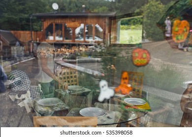 Dinner Table Served For Family By Woman View From Outside Through A Window