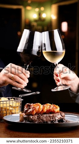 dinner table for two with toast two glasses of surf and turf wine with blackberry jam in focus in restaurant out of focus in background