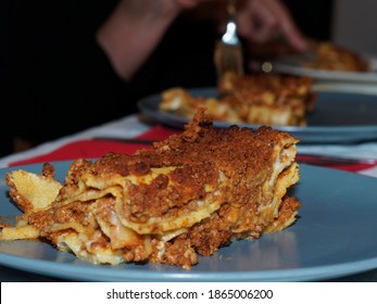 Dinner Time At Home With Friends And Family. A Typical First Course Of Italian Cuisine, Lasagna, Made With Minced Meat And Tomato Sauce.