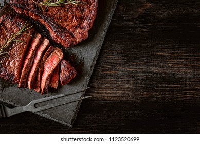 dinner for two with steaks and red wine - Shutterstock ID 1123520699