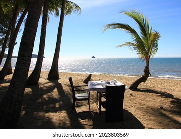 'dinner For Two'. Table Set On The Beach With Palm Trees