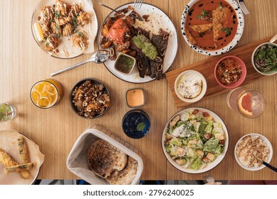 Dinner unfolds with a stunning array of dishes, showcasing bright colors and enticing aromas. Diners enjoy a warm atmosphere, indulging in diverse flavors and shared moments.