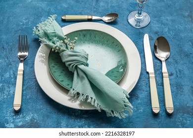 Dinnerware And Gypsophila Flowers On Blue Table