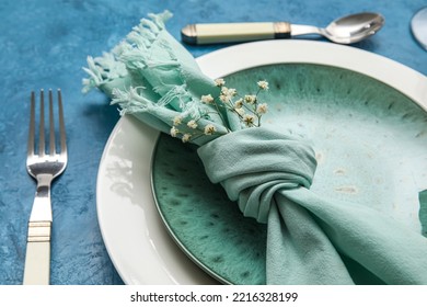 Dinnerware And Gypsophila Flowers On Blue Table