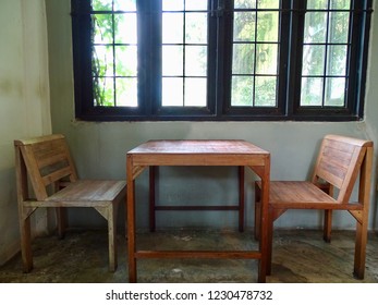 Dinning Table set by the window. Wooden chairs and Table by the window in the old house.