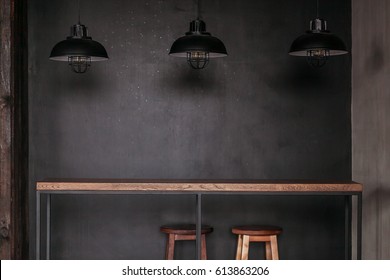 Dinning table set in loft style dining room with black lamps - Powered by Shutterstock